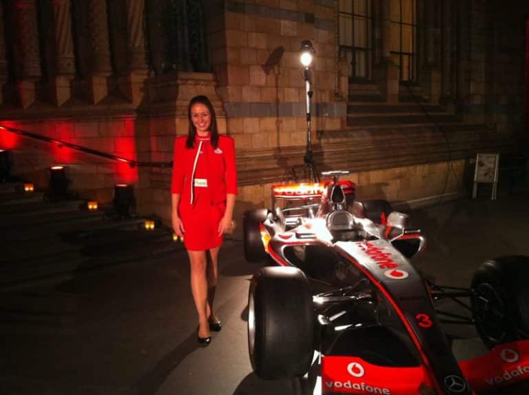 Santander event staff standing next to a racing car